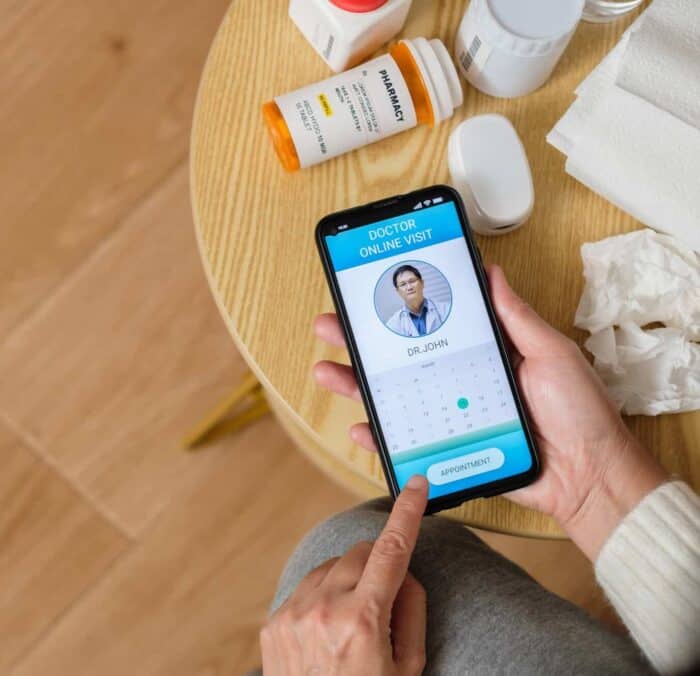 Convenient online doctor appointment booking via mobile app on smartphone for telehealth services.