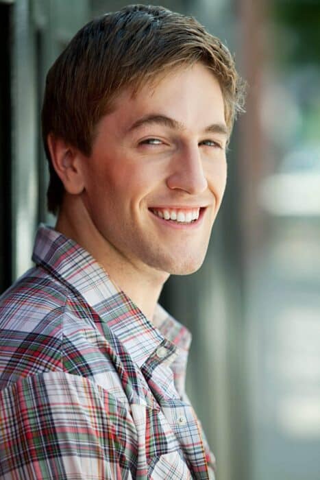portrait young man smiling - Smiling young man in a casual shirt