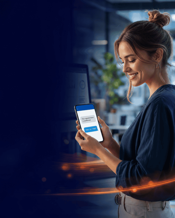 A woman smiling while using the AiDial mobile app on her smartphone in a modern office environment, showcasing AI-powered communication technology.
