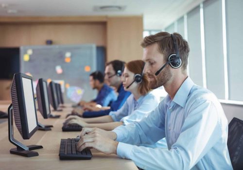 Businessman typing on keyboard at call center