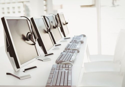 Call center computers and headsets all in a row